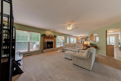Newer carpeting in open family room with wood fire