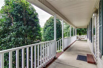 Look at this beautiful wrap-around front porch! Perfect for sipping sweet tea! 