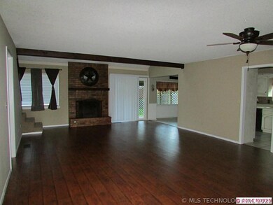 Great room with new flooring and wood burning fire