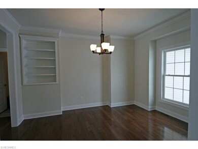 Formal dining room with hardwood flooring, crown m