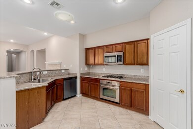 Kitchen with a peninsula, a sink, visible vents, a