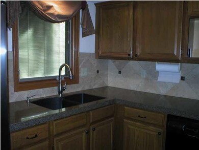 Kitchen- Tile backsplash, granite countertop, blin