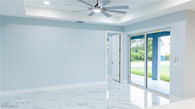 Unfurnished room featuring a tray ceiling, a ceili