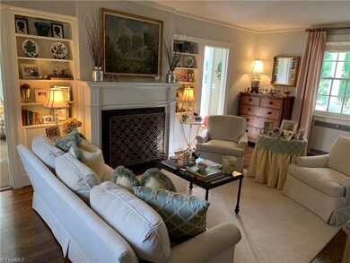 Formal living room with built-in bookshelves & gas log fireplace