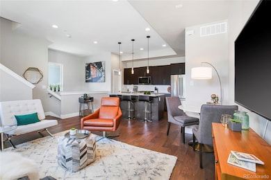 Another view of the living, dining and kitchen areas with engineered wood floors for beauty and durability.