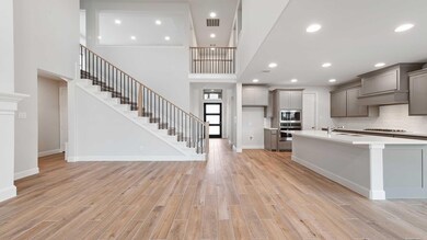 Kitchen featuring sink, gray cabinetry, light wood