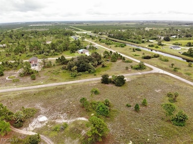 Aerial view of property's location with a large body of water