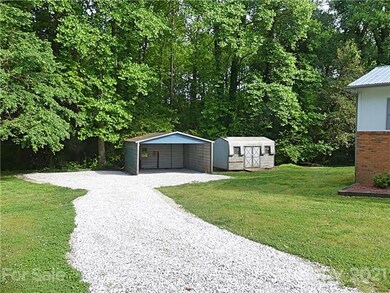 Freshly put in gravel drive to carport area