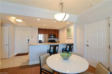 Dining space with crown molding, baseboards, and l