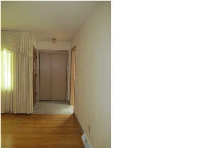 Newly tiled entry with nice sized coat closet.