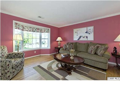 The spcious living room has gleaming hardwood floo