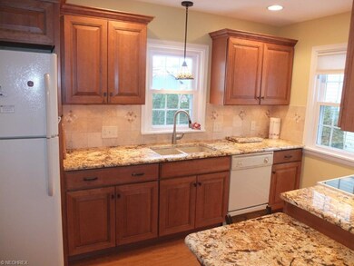 Remodeled kitchen has granite countertops, tile ba