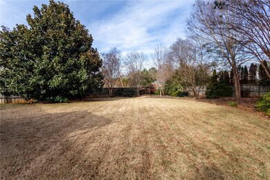 Level backyard with mature Magnolia tree.