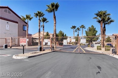 View of street with curbs, a gated entry, and a ga
