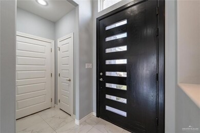 foyer. coat closet and door to garage 