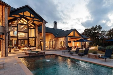 View of pool featuring several patio areas and a p