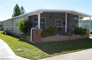 View of front of home with central air condition unit and a front yard
