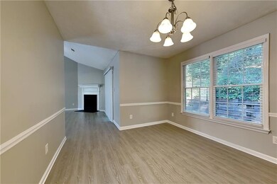 Unfurnished room featuring a chandelier, light har