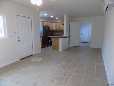 Kitchen featuring a kitchen breakfast bar, a wall