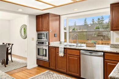 The bay window views to the deck; the dining room is located to the left. Not pictured: NEW Thermodor microwave, oven and Bosch cooktop. 