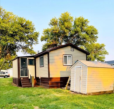 NE exterior and shed