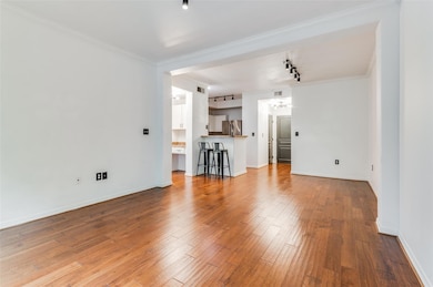 Living room featuring ornamental molding, light ha