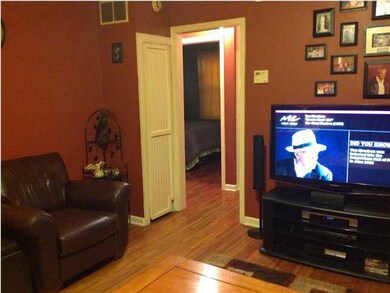 LIVING ROOM DOOR LEADS TO HALL WITH BATHROOM AND B