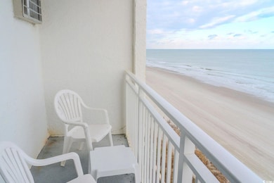 Balcony with view of water and beach