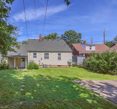 Rear view of property with a yard