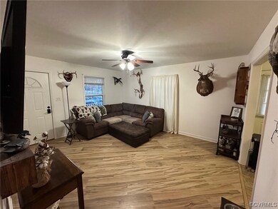Living room with light wood-type flooring and ceil