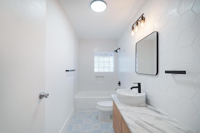 Bathroom with tile patterned flooring, shower / b
