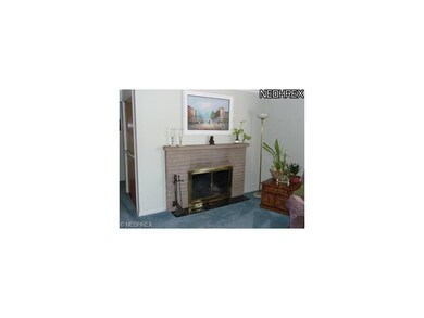 stone fireplace accents the spacious living room.