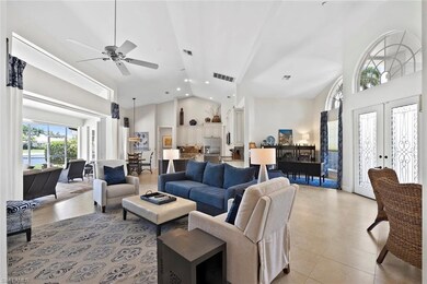 Living area with high vaulted ceiling, light tile patterned floors, a ceiling fan, and recessed lighting