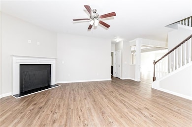 Unfurnished living room with ceiling fan, wood fin