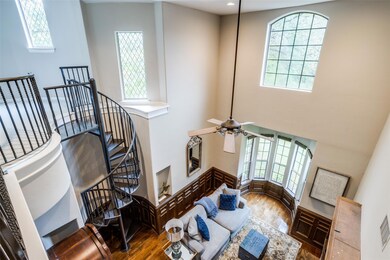 Spiral staircase leading to a bonus room with buil