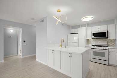 Kitchen featuring white appliances, backsplash, a
