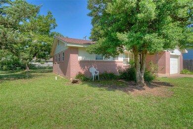 View of home's exterior with brick siding and concrete driveway