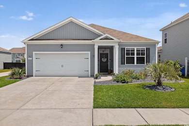View of front of property with a front yard, driveway, an attached garage, and roof with shingles