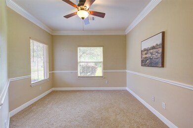 Bright home office with French doors and crown mol