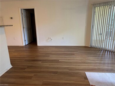 Unfurnished room with dark wood-type flooring