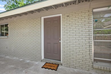 Property entrance featuring brick siding