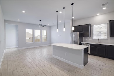 Kitchen with stainless steel appliances, light co