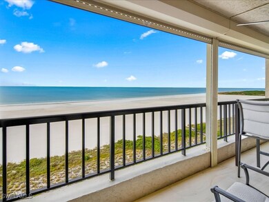 Balcony with view of water and beach