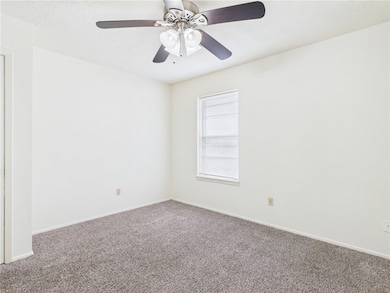 Carpeted empty room featuring baseboards