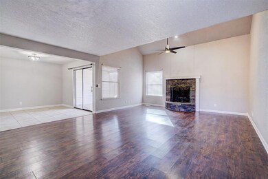 Unfurnished living room featuring a textured ceili