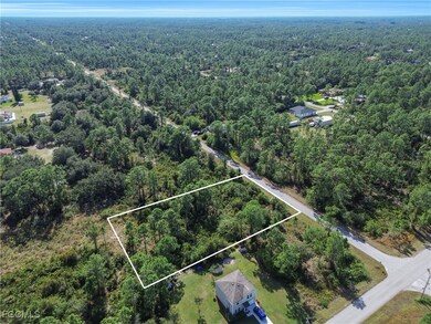 Aerial overview of property's location featuring a heavily wooded area and property boundaries highlighted
