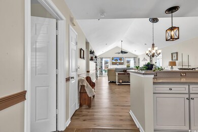 Hallway with lofted ceiling, light wood-style floo