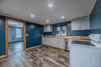 Kitchen featuring white electric range, dishwasher, recessed lighting, dark wood finished floors, and butcher block countertops