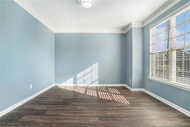 Living room or office featuring crown molding, woo