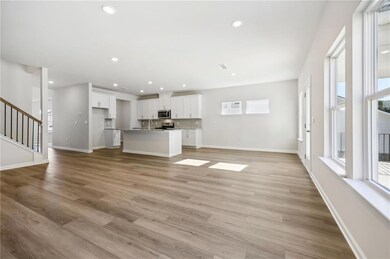 Unfurnished living room with stairs, light wood-style flooring, and recessed lighting
